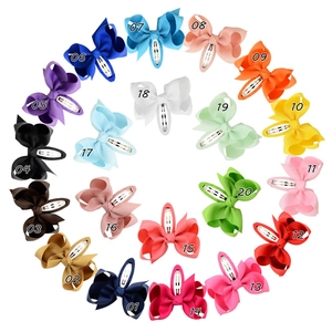 Detail of 20 color grosgrain ribbon bow hair clips with metallic snap clips in circular array