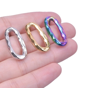 Detailed view of 304 stainless steel oval hoop earrings in silver, gold, and rainbow finishes