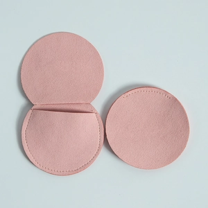 Detail of round pink microfiber jewelry pouch with soft suede texture and stitching
