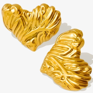 Macro detail of gold 304 stainless steel heart earrings with irregular lava texture