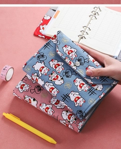 Detailed view of Maneki Neko fabric binder notebook with loose-leaf rings and inner pages
