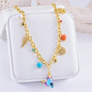 Golden planet necklace with purple heart pendant and charms on white jewelry box cushion