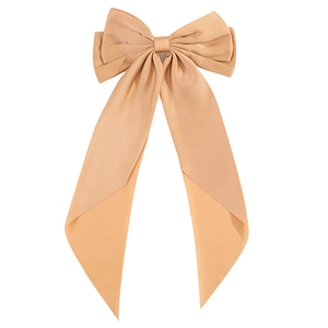 Elegant large beige bow hair clip with long silk ribbons on a clean white background