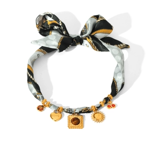 Silk scarf with gold chain featuring ladybug, heart, and brown gemstone pendants
