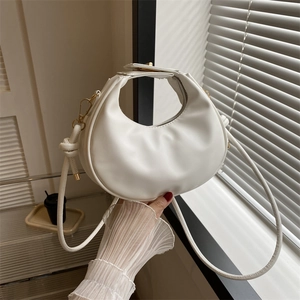 Minimalist white crescent shoulder bag in smooth PU leather with golden hardware accents
