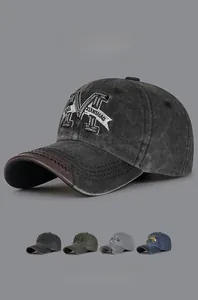 Detail of vintage washed baseball cap showing embroidered M and leather brim piping