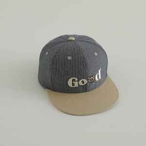 Detailed macro view of Bear Good embroidery on blue striped baseball cap for kids