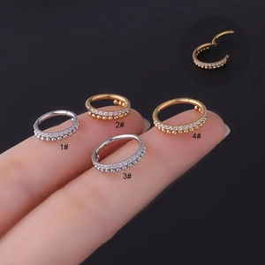 Macro detail of stainless steel hinged segment rings with cubic zirconia and bead accents