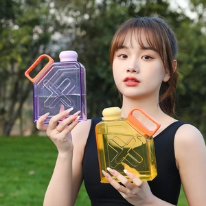Close-up of square plastic water bottles in purple and yellow with orange handles