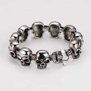 Close-up of vintage silver skull link bracelet with detailed antique finish metalwork