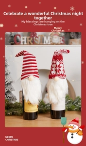 Detail of red and white knitted Christmas gnome wine bottle covers with faux fur beards
