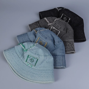 Detailed overhead view of four distressed denim bucket hats with letter f embroidery