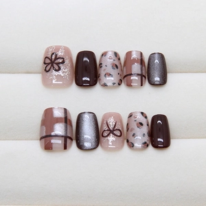 Retro leopard and plaid press-on nails with floral and cat eye designs in earth tones