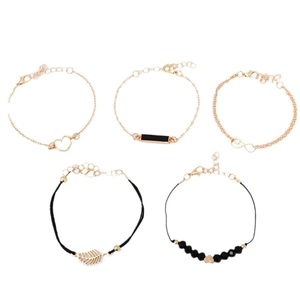 5-piece gold and black bracelet set with heart, leaf, and infinity charms on white background