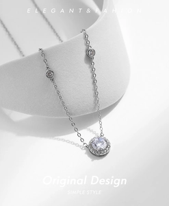Detail of S925 silver halo necklace with round sparkling zircon and side stones