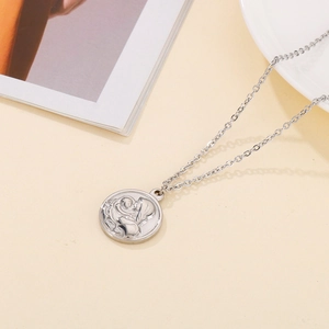 Macro shot of silver Virgin Mary and Child relief pendant on stainless steel chain