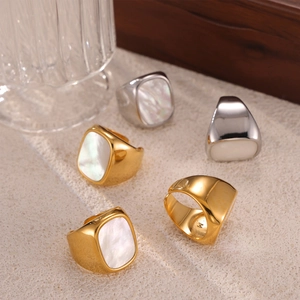Hepburn style wide gold and silver rings with white mother of pearl inlay on textured base