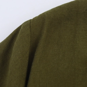 Close-up of dark green twill woven fabric texture showing fine weave details