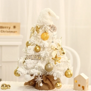 Mini flocked white Christmas tree with gold ornaments and NOEL sign on a burlap base