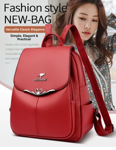 Close-up of red pebbled leather backpack with decorative metal kangaroo and swan hardware