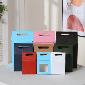 Minimalist multi-color gift boxes with handles and window in a warm home setting