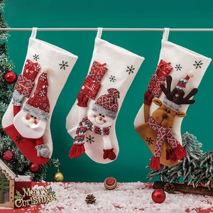 Three festive Christmas stockings featuring Santa, Snowman, and Reindeer on a dark backdrop