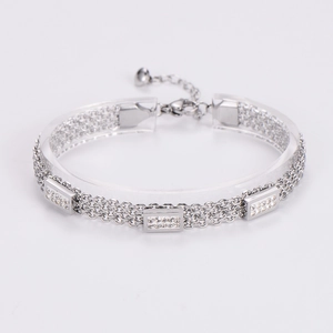Detail of silver triple-layered stainless steel bracelet with zircon-set rectangles