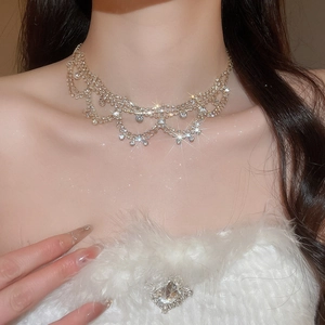 Detail view of a luxury gold-plated layered necklace featuring sparkling crystal rhinestones
