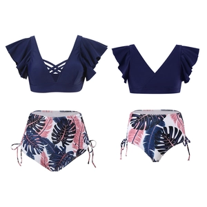 Navy blue V-neck bikini top with ruffles and high-waisted tropical leaf print bottoms