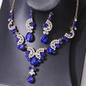 Detail of luxury bridal jewelry set with navy blue crystals and gold-tone finish