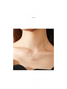 Detail of s925 sterling silver necklace with sparkling solitaire round-cut zircon on model