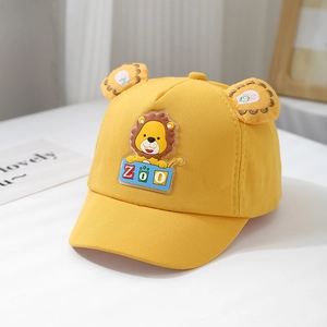 Close-up of yellow baby baseball cap featuring cartoon lion patch and cute 3D ears