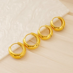 Detailed view of four thick 18k gold-plated stainless steel hoop earrings with mirror finish