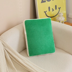 Green sherpa mahjong throw pillow on a modern cream fleece chair in a cozy living room