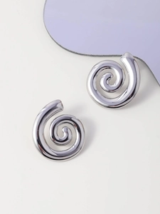 Detailed view of polished silver spiral earrings with smooth metallic finish