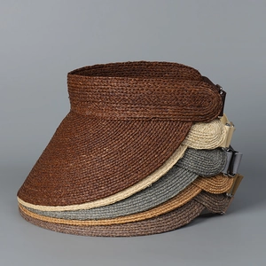 Close-up of premium woven raffia sun hats showing detailed spiral texture and adjustable strap