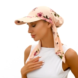Side view of floral headscarf hat in pink with rose patterns and adjustable tie straps