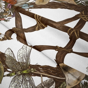 Macro shot of mandala tapestry fabric showing dragonfly and botanical illustration details