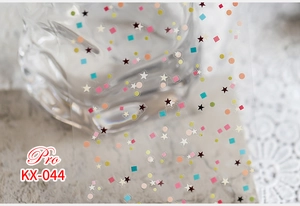 Macro shot of colorful star and circle nail stickers for DIY manicure decoration