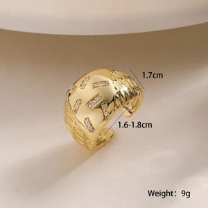 Macro shot of gold-plated wide geometric ring with zircon inlay and weight specifications