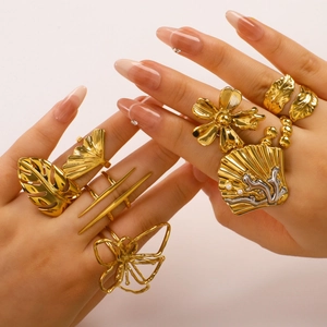 Golden ocean inspired geometric rings set featuring floral and shell designs on hand