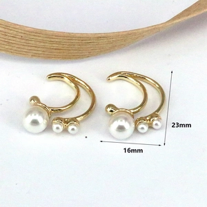 Macro view of gold pearl earrings showing size dimensions of 23mm height and 16mm width