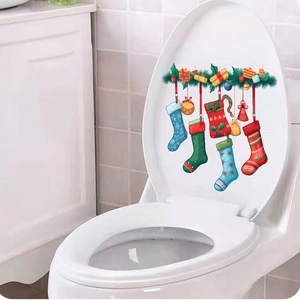 Detailed view of festive Christmas stocking stickers on a clean bathroom toilet lid