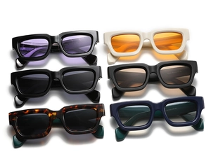 Flat lay display of retro rectangular sunglasses in various colors on white background