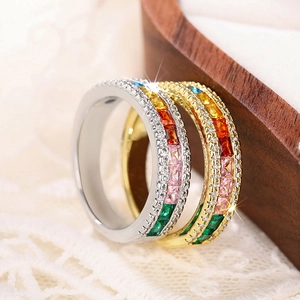 Macro view of dual-layer rainbow zircon rings with silver and gold metal finish