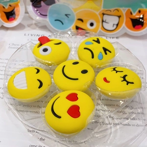 Close-up of six creative yellow emoji erasers in creative astronaut themed gift packaging