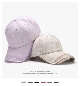 Detail of distressed baseball caps with letter embroidery and frayed edges