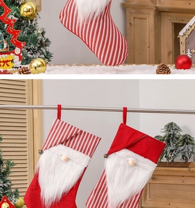 Close-up of three striped Christmas gnome stockings with plush beards and bells