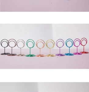 Row of colorful spiral heart-shaped metal memo holders in ten vibrant assorted finishes