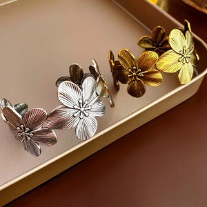 Detail of vintage flower cuff bracelet with antique gold and silver metallic finish
